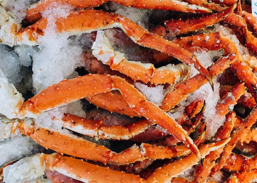 Cooked snow crab legs piled on ice